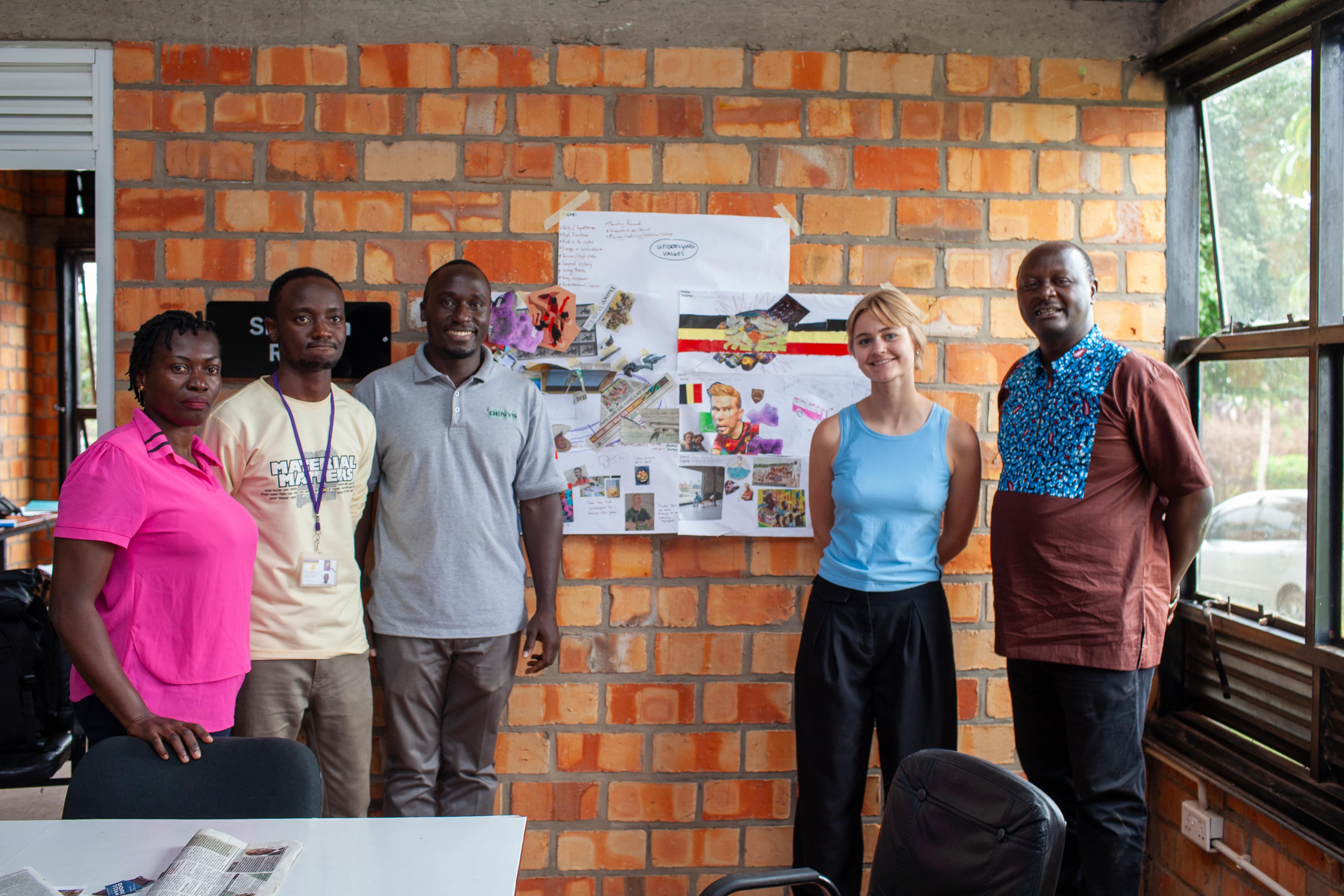 Team proudly presents their completed board, explaining their design concept to the rest of the group.
