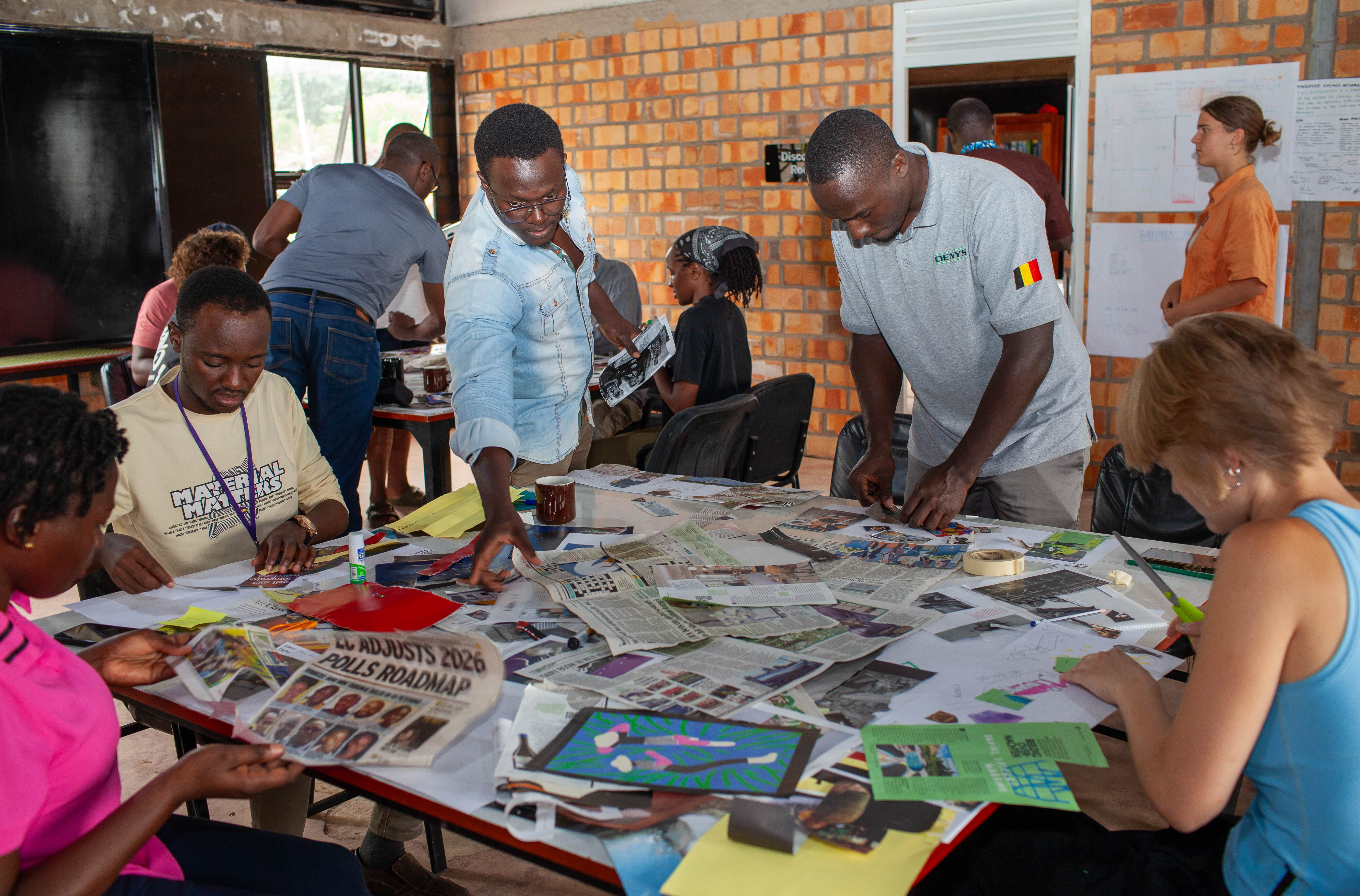A hive of activity as the team works together, cutting and pasting to visualize their installation ideas.