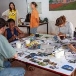 Participants are deeply focused on creating mood boards, a key step in the design process